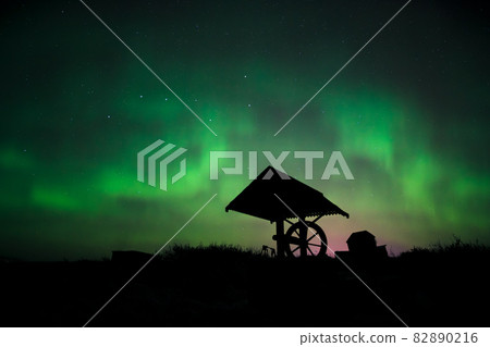 Aurora in the starry sky above the well 82890216