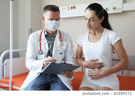 Doctor conducts medical examination of female patient in clinic Doctor conducts medical examination of female patient in clinic 82890371