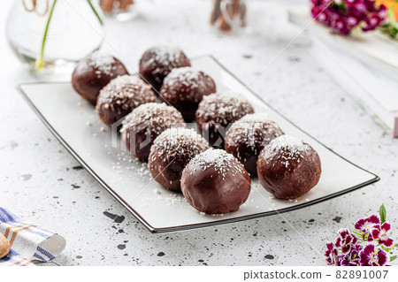 Plate of sweet chocolate balls with coconut Plate of sweet chocolate balls with coconut 82891007