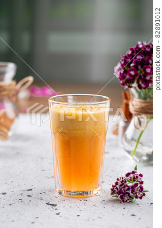 Glass of fresh orange juice on a light background Glass of fresh orange juice on a light background 82891012