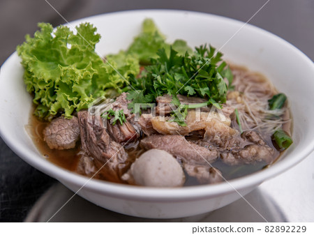 Thai beef clear soup white rice noodle vermicelli with braised beef, meatball and vegetable. 82892229
