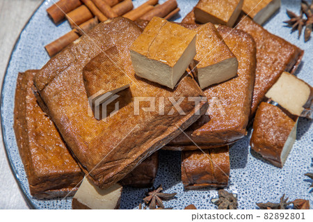 Traditional black herb tofu on ceramic plate. Traditional black herb tofu on ceramic plate. 82892801