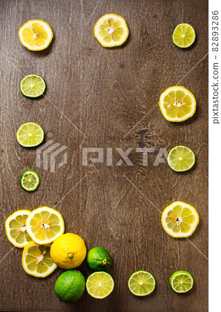 sliced lemon, lime on slate and wooden counter top background sliced lemon, lime on slate and wooden counter top background 82893286