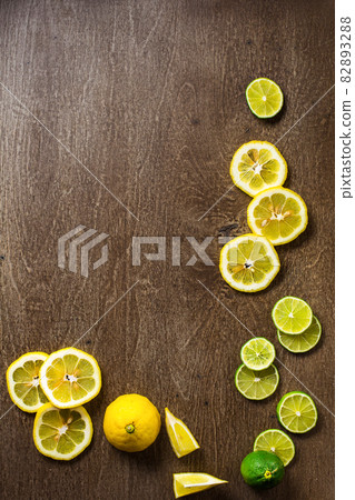 sliced lemon, lime on slate and wooden counter top background sliced lemon, lime on slate and wooden counter top background 82893288