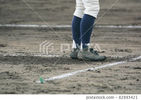 A coach who speaks to and inspires players during a baseball game A coach who speaks to and inspires players during a baseball game 82893421