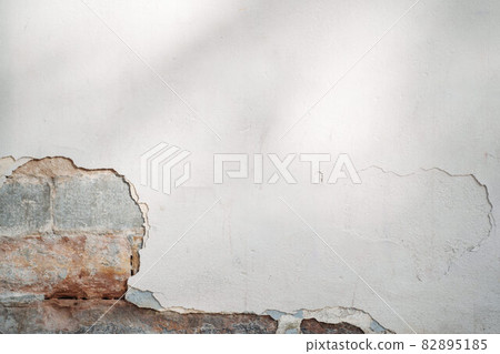 white wall with chipped away paint and brick detail white wall with chipped away paint and brick detail 82895185