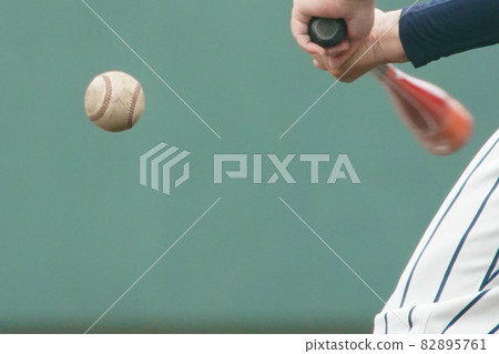 Baseball coach's bat and hit ball while knocking on a baseball seat Baseball coach's bat and hit ball while knocking on a baseball seat 82895761