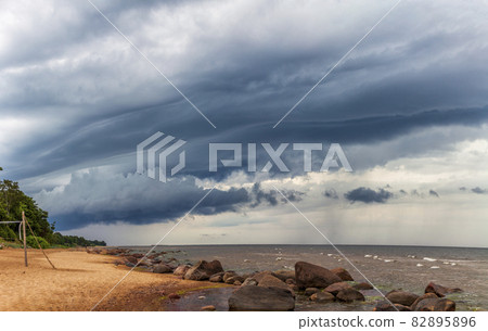 Wall cloud over sand beach Wall cloud over sand beach 82895896