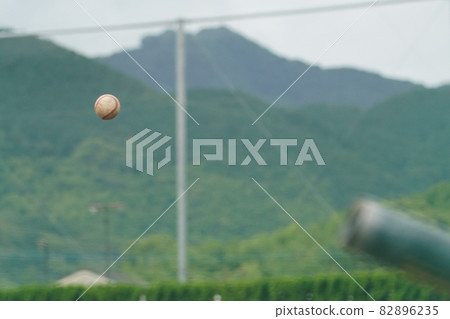 A white ball thrown at a batter by a pitcher during a baseball game A white ball thrown at a batter by a pitcher during a baseball game 82896235