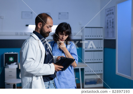 Doctor and nurse working late at night for healthcare Doctor and nurse working late at night for healthcare 82897193