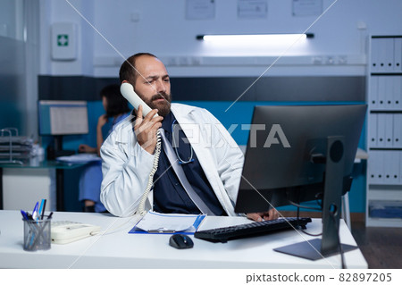 Medic using landline phone for remote communication overtime Medic using landline phone for remote communication overtime 82897205