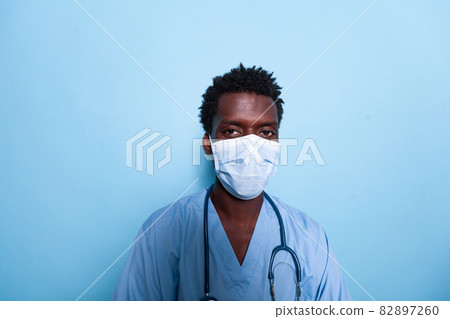 Portrait of medical assistant wearing face mask and uniform Portrait of medical assistant wearing face mask and uniform 82897260