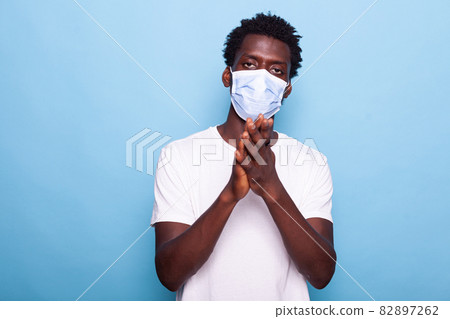 Portrait of adult using hands to applaud and having face mask Portrait of adult using hands to applaud and having face mask 82897262