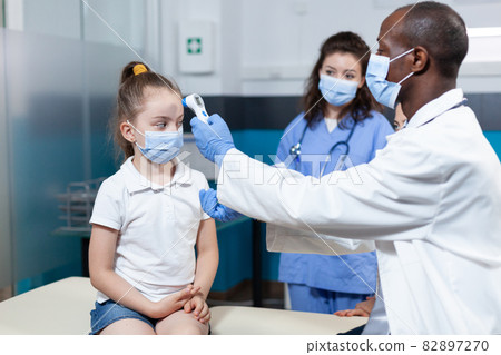 African american pediatrician doctor with face mask against coronavirus African american pediatrician doctor with face mask against coronavirus 82897270