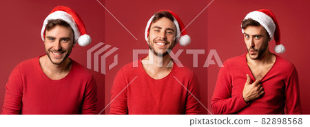 Young handsome caucasian guy in red sweater and Santa hats stands on red background in studio Shows how hot he is 82898568