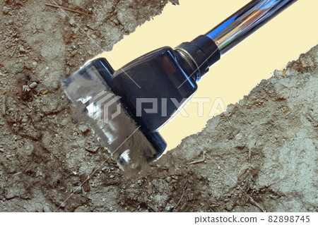 Head of the vacuum cleaner with a rotating brush cleans a transparent floor. Head of the vacuum cleaner with a rotating brush cleans a transparent floor. 82898745