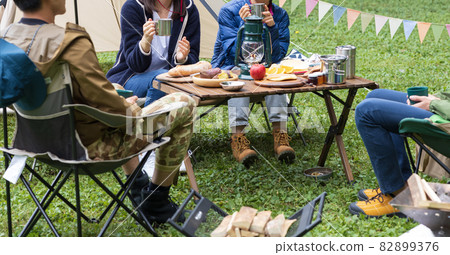 Young men and women enjoying camping Young men and women enjoying camping 82899376