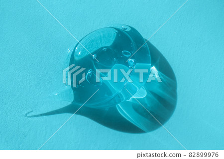 Macro, close up of transparent droplet of skincare product. Aloe vera cleanser with bubbles, lotion smear, styling gel swatch, shampoo drop. Squeezed cosmetic gel blob smudge 82899976