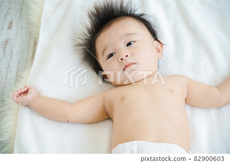 Baby lying on his back Baby lying on his back 82900603