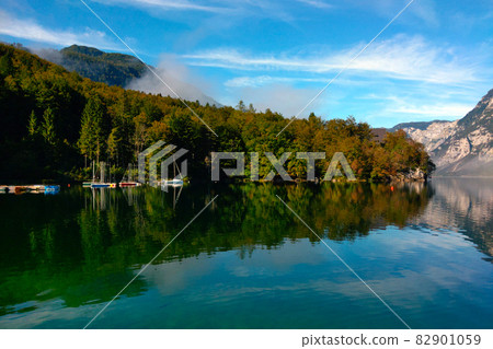 Picturesque view of the mountain lake on a foggy autumn morning. Picturesque view of the mountain lake on a foggy autumn morning. 82901059
