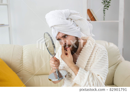 Bearded man checking his skin of face. Spa, body and skin care for male concept. 82901791