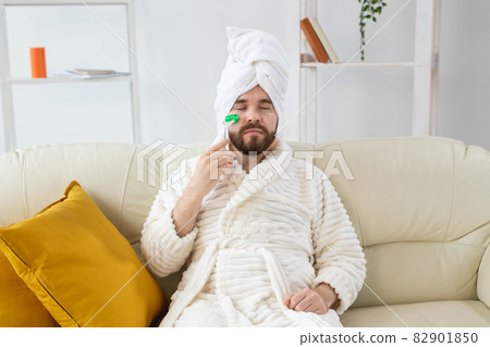Bearded man with facial massage tool. Male skin care and spa concept. 82901850