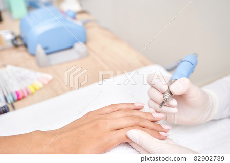 Beautiful salon procedure with pink manicure on towel background. Nail polish Beautiful salon procedure with pink manicure on towel background. Nail polish 82902789