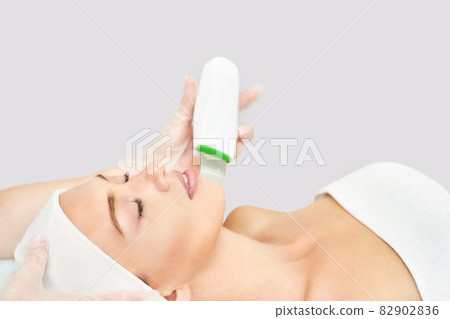 Ultrasound cosmetology scrubber. Face cavitation procedure. Salon skincare Ultrasound cosmetology scrubber. Face cavitation procedure. Salon skincare 82902836