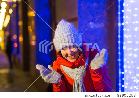 Girl in a night city snowflake Christmas city lights. Christmas and winter holidays concept. 82903298