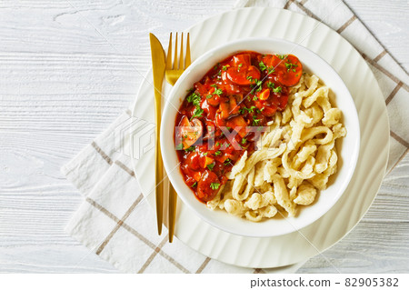 spaetzle with mushroom gravy in a white bowl spaetzle with mushroom gravy in a white bowl 82905382