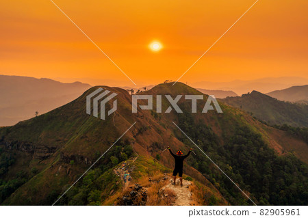 traveler man hiking enjoying in the mountains with backpack at Khao Chang Puak mountain Thailand 82905961