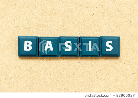 Tile alphabet letter in word basis on wood background Tile alphabet letter in word basis on wood background 82906057