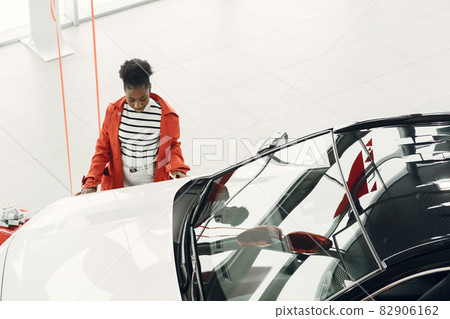 Young african american woman in car salon Young african american woman in car salon 82906162