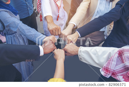 Diverse multiethnic Partners hands together teamwork group of multi racial people meeting join hands togetherness. Diversity people hands join empower partnership teams connection volunteer community Diverse multiethnic Partners hands together teamwork group of multi racial people meeting join hands togetherness. Diversity people hands join empower partnership teams connection volunteer community 82906371
