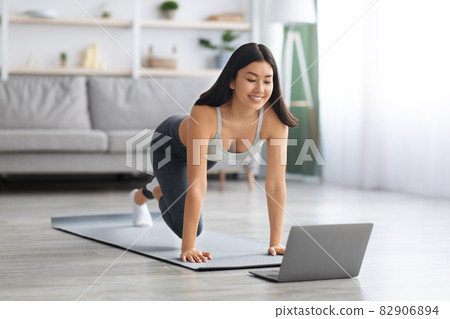Happy Fit Asian Lady Making Online Sport Trainings At Home With Laptop Happy Fit Asian Lady Making Online Sport Trainings At Home With Laptop 82906894