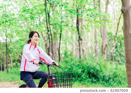 Young woman enjoying cycling in nature Young woman enjoying cycling in nature 82907009