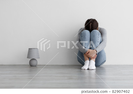 Worried sad millennial woman suffering from depression and mental illness, lady feeling lonely after quarrel 82907402