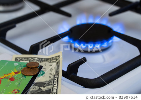 Shortage and gas crisis. Money on the background of a burning gas stove 82907614