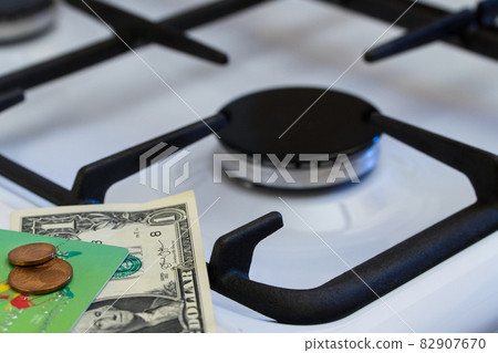 Shortage and gas crisis. Money on the background of a switched off gas stove 82907670
