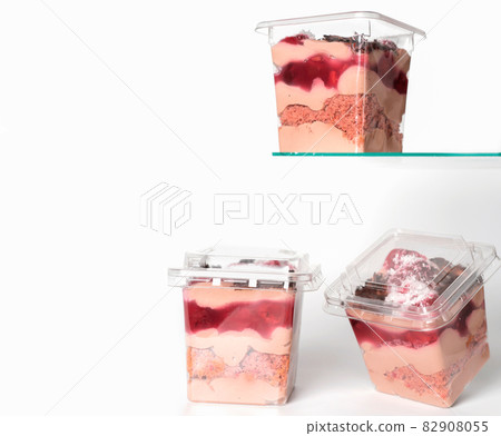 take away trifle cake in a box. chocolate sponge bisquit with mascarpone and cherry berry jam filling. coconut and grated chocolate topping. autumn season sweet treats, copy space 82908055