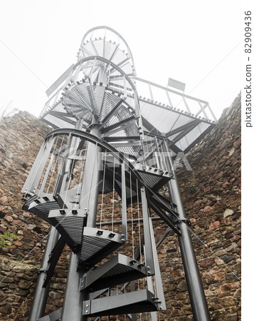 Defence tower of Lichnice castle ruin in heavy mist. Czech republic travel Defence tower of Lichnice castle ruin in heavy mist. Czech republic travel 82909436