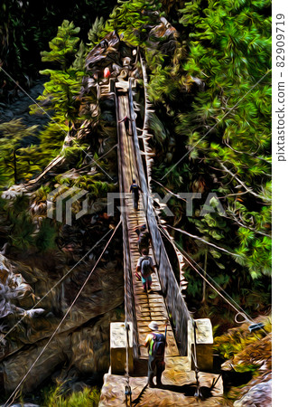 People crossing precarious suspension bridge in Nepal People crossing precarious suspension bridge in Nepal 82909719