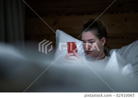 Smartphone usage in bed at night 82910065