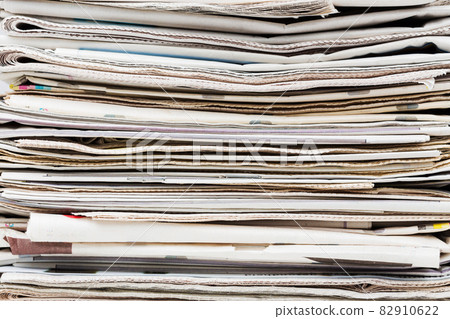 Pile of stacked generic folded newspapers background 82910622