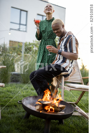 Young couple drinking cocktails at home party Young couple drinking cocktails at home party 82910858