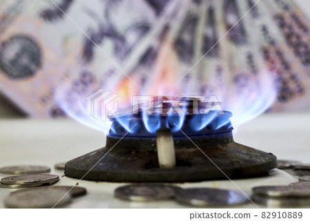 Burning gas stove burner and Uzbek money - sum banknotes. Pay for natural gas, bill, tariff. Growing tariffs for gas. Pile of coins and burning fire gas stove hob and money Burning gas stove burner and Uzbek money - sum banknotes. Pay for natural gas, bill, tariff. Growing tariffs for gas. Pile of coins and burning fire gas stove hob and money 82910889