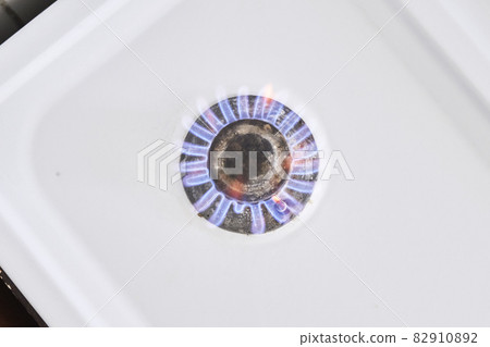 Burning flame on gas stove burner. Burning gas. Hob in the kitchen. Kitchen gas cooker with burning fire propane gas Burning flame on gas stove burner. Burning gas. Hob in the kitchen. Kitchen gas cooker with burning fire propane gas 82910892
