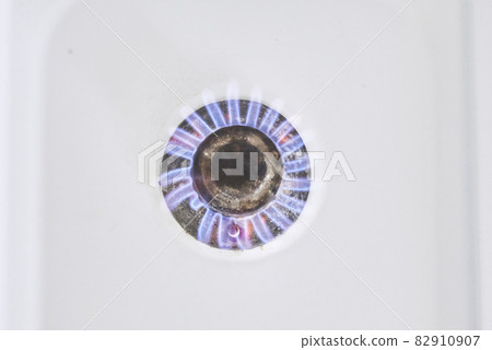 Burning flame on gas stove burner. Burning gas. Hob in the kitchen. Kitchen gas cooker with burning fire propane gas Burning flame on gas stove burner. Burning gas. Hob in the kitchen. Kitchen gas cooker with burning fire propane gas 82910907