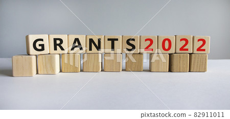 Business concept of grants planning 2022. Words 'Grants 2022' on wooden cubes. Beautiful white background. Business and grants 2021 new year concept. Copy space. 82911011