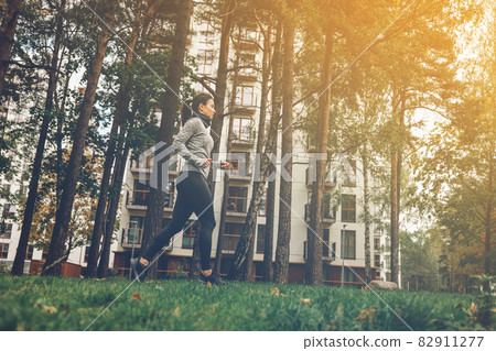 Woman running in the city park. Exercising outdoors 82911277